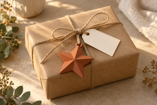 Kraft-wrapped gift tied with twine and a removable terracotta 3D-printed star ornament