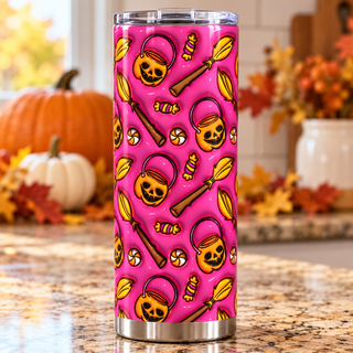 Pumpkin buckets, brooms and candy on pink — one tumbler in kitchen setting