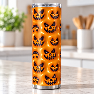 Black jack-o-lantern faces on orange — single tumbler on kitchen counter