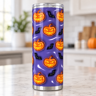 Jack-o-lanterns and bats on blue-purple — single tumbler on kitchen counter
