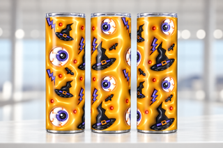 Eyeballs, witch hats and lightning on yellow — three views of one stainless steel tumbler